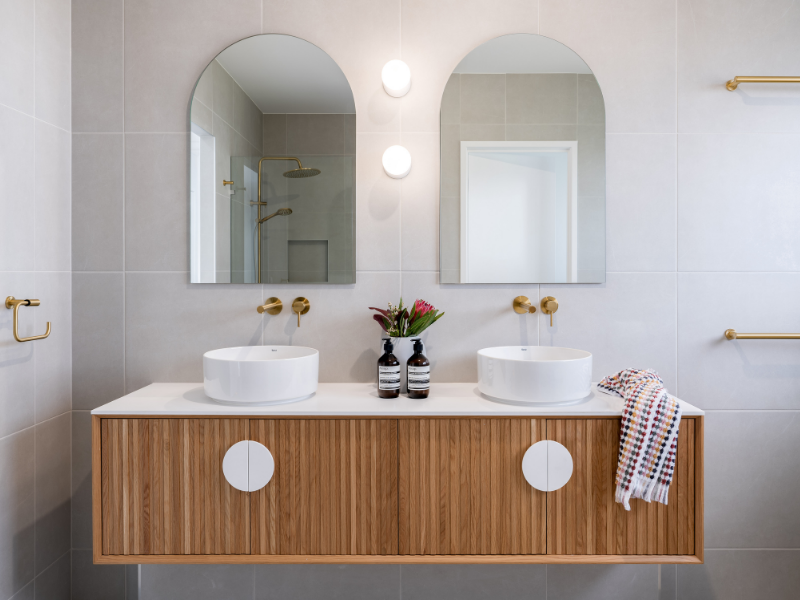 Modern Bathroom with Timber Groove Cabinet and Arched Mirrors