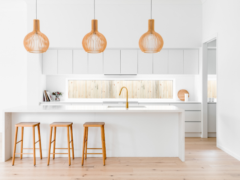 White Kitchen with Timber Flooring and Oak Barstools and Pendants