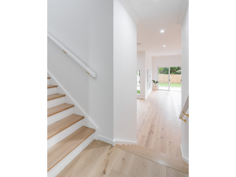 Split Level staircase with timber flooring and white rises