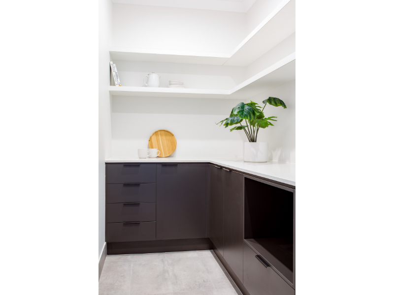 Butler's Pantry with dark cabinetry and white open shelves